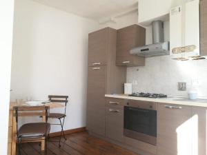 a kitchen with wooden cabinets and a table and a stove at Casa Iolanda in Siena +12 photos