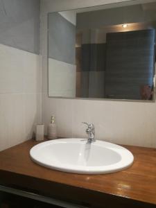 a white sink in a bathroom with a mirror at Casa Iolanda in Siena