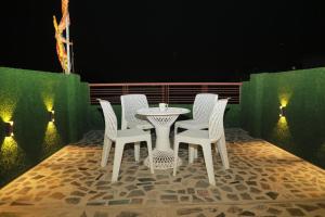 a table and chairs on a patio at night at De Classico Hotel in Varanasi