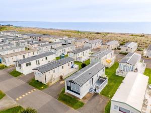 an aerial view of a row of houses next to the ocean at 30 Bayside Cove Pevensey Bay Holiday Park in Pevensey