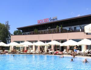 a pool at a hotel with people in the water at Belchin Garden SPA&Wellness in Belchin