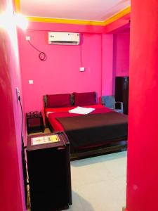 a red bedroom with a bed in a room at Small Daddy Baga Beach in Baga