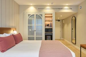 a bedroom with a large white bed with red pillows at Catalonia Barcelona 505 in Barcelona