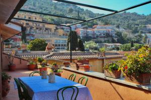 a table on a balcony with a view of a city at [Porto S. Stefano] Elegant House + Swimming Pool in Porto Santo Stefano