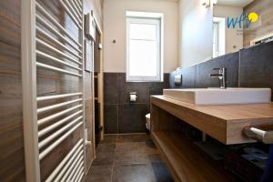 a bathroom with a sink and a mirror at Alte Feuerwache Ferienwohnung 1 in Wangerooge +33 photos
