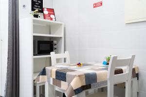 a small dining room with a table and two chairs at Casa da Carochinha in Nazaré