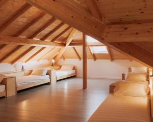 a attic room with two beds and wooden ceilings at Quinta da Quinhas in Vila Praia de Âncora