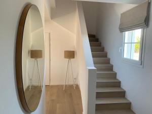 a hallway with a mirror and a stairway at Les Collines de Saint-André in Saint-André-de-Cruzières