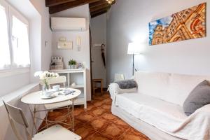 a living room with a white couch and a table at Granada FreshApartments by Bossh! Apartments in M&aacute;laga
