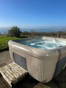 a bath tub with a bench next to it at The Old Lookout in Osmington