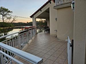 a balcony of a house with a view of a river at GITE DE CHARME in Changey
