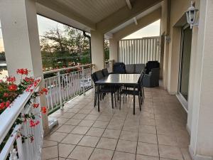 a patio with a table and chairs on a balcony at GITE DE CHARME in Changey +10 photos