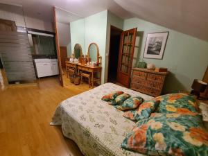 a bedroom with a bed and a table in it at GITE DE CHARME in Changey