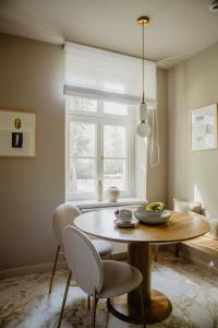 a dining room with a table and chairs and a window at Hotel Schloss Teutschenthal in Teutschenthal