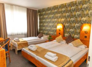 - une chambre d'hôtel avec 2 lits dans l'établissement Hotel Rossija, à Francfort-sur-le-Main