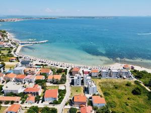an aerial view of a beach with houses and the ocean at Apartments THE BEACH RESORT VIR in Vir