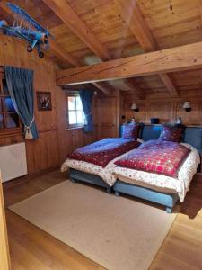 a bedroom with a bed in a room with wooden ceilings at Chalet de 4 chambres avec jacuzzi terrasse et wifi a Megeve a 2 km des pistes in Megève