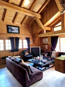 a living room with a couch and a table at Chalet de 4 chambres avec jacuzzi terrasse et wifi a Megeve a 2 km des pistes in Megève