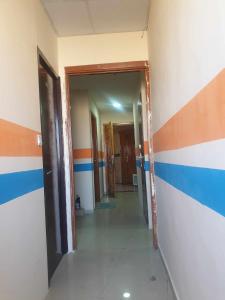 an empty hallway with blue and orange stripes on the walls at Sahara Hostel and Private rooms in Dubai