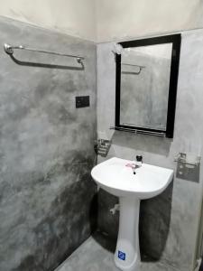 a bathroom with a white sink and a mirror at Pearl Villa23 in Tangalle