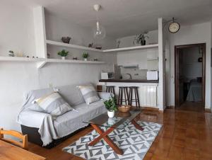 a living room with a couch and a table at Casa Tere in Benitachell