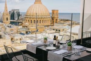 a restaurant with a view of the city at The Embassy Valletta Hotel in Valletta