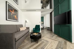 a living room with a couch and a table at The Embassy Valletta Hotel in Valletta