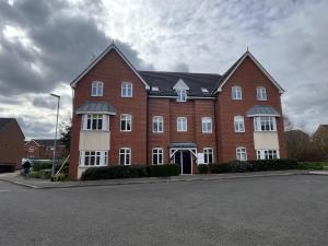 a large red brick building with white windows at Beautiful 2-Bed Apartment near Lincoln City Centre in Lincoln