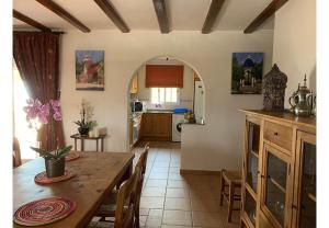 a kitchen and dining room with a table and chairs at Casa Romero in La Font D´En Carròs