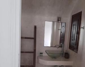 a bathroom with a sink and a mirror at Beautiful Santorini Villa 1 Bedroom Suite Villa Laxus Pyrgos in Pyrgos