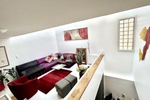 a living room with a couch and a table at Rare Parisian Architect House in Paris