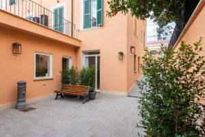 a bench sitting in the courtyard of a building at Major House - Luxury Apartments in Rome