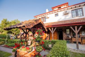a garden with a wooden pergola in front of a building at Apartment in Antique Museum Filip in Bitola