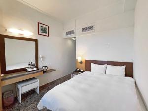Postel nebo postele na pokoji v ubytování Foung Kou Hotel