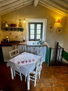 a kitchen with a white table and a sink at B&B La Cervaiola in Porano
