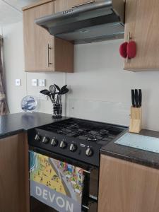a kitchen with a black stove top oven at Endless Summer in Barnstaple