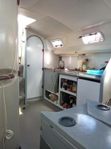 an interior view of an rv with an open refrigerator at Chambre sur un voilier in Sainte-Anne