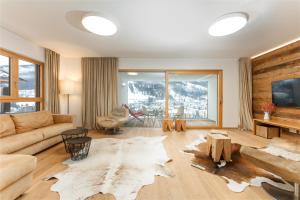 a living room with a couch and a table at Sun Lodge Schladming by Schladming-Appartements in Schladming