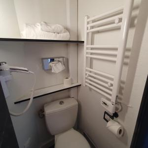 a small bathroom with a toilet and a sink at Kyriad Villefranche Sur Saone in Villefranche-sur-Saône