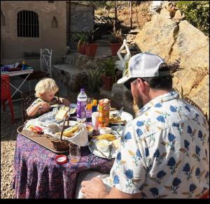 a man and a child sitting at a table eating food at Raj Haveli- A Heritage Samode in Jaipur +31 photos