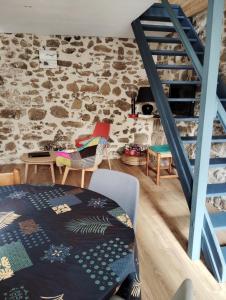 a room with a staircase and a stone wall at Maison de pêcheurs in Saint-Quay-Portrieux