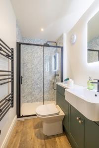 a bathroom with a shower and a toilet and a sink at Boutique Stays at 78 in Bangor