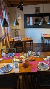a table with plates and utensils on top at Bed and Breakfast Am Schwatten Berg in Heek