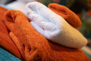 a stuffed animal laying on top of a blanket at Boutique Stays at 78 in Bangor