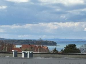 a view of a body of water from a highway at Udsigten. in Ebeltoft