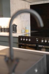 a kitchen with a black stove top oven at Boutique Stays at 78 in Bangor