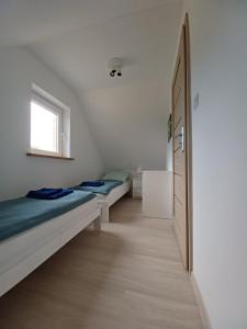 1 dormitorio con 2 camas y ventana en Domek, domki na Mazurach. Okolice Olecka, en Swiętajno
