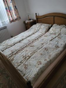 an unmade bed in a bedroom with a bedspread on it at Vila Garanga in Luke