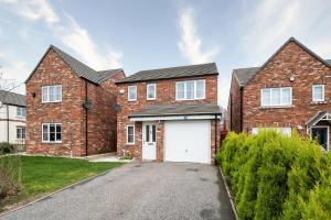 a brick house with a white garage at Modern House with Parking and Garden in Doncaster