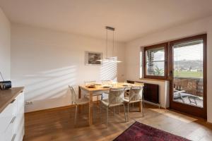 a kitchen and dining room with a table and chairs at Haus Kexel in Sankt Johann in Tirol